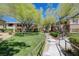 Scenic view of condos with a walkway lined with trees and landscaping at 701 Peachy Canyon Cir # 201, Las Vegas, NV 89144