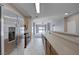Open kitchen with stainless steel refrigerator and view to living area at 701 Peachy Canyon Cir # 201, Las Vegas, NV 89144