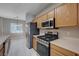 This spacious kitchen features stainless steel appliances and wood cabinetry at 701 Peachy Canyon Cir # 201, Las Vegas, NV 89144