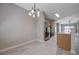 Well-lit kitchen and dining area with stainless steel appliances and a modern chandelier at 701 Peachy Canyon Cir # 201, Las Vegas, NV 89144