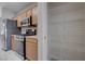 Modern kitchen with stainless steel appliances and pantry at 701 Peachy Canyon Cir # 201, Las Vegas, NV 89144