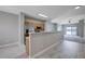 Open-concept kitchen with stainless steel appliances and a breakfast bar overlooking the living area at 701 Peachy Canyon Cir # 201, Las Vegas, NV 89144