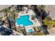 Aerial shot of sparkling community pool with lounge seating, lush greenery, and luxury amenities at 701 Peachy Canyon Cir # 201, Las Vegas, NV 89144
