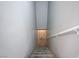 Carpeted stairs with a white handrail, leading downward, offering a practical and safe passage at 701 Peachy Canyon Cir # 201, Las Vegas, NV 89144