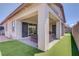 Beautiful backyard featuring a covered patio, lounge furniture, putting green, and synthetic lawn at 709 Corelli Cove St, Henderson, NV 89011