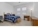 Bedroom with hardwood-style flooring, a ceiling fan, desk, and blue plaid bedding at 709 Corelli Cove St, Henderson, NV 89011