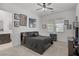 Bedroom with dark grey bed, carpet, ceiling fan, and an attached bathroom with dual sinks at 709 Corelli Cove St, Henderson, NV 89011