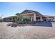 Elegant building exterior featuring a circular driveway, manicured landscaping, and covered entrance at 709 Corelli Cove St, Henderson, NV 89011