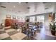 Spacious dining area with long tables, chairs, and contemporary decor at 709 Corelli Cove St, Henderson, NV 89011