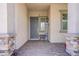 Inviting front porch features brick pavers, a welcome sign, and stylish stone columns, creating a warm entry at 709 Corelli Cove St, Henderson, NV 89011
