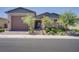 Charming single story home features a well maintained lawn, desert landscaping, and an attached two car garage at 709 Corelli Cove St, Henderson, NV 89011