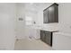 Laundry room with dark cabinets, a folding station, and a washer and dryer set at 709 Corelli Cove St, Henderson, NV 89011