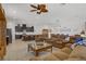 Expansive living room features a ceiling fan, comfortable seating, and flows into an open floor plan with plenty of natural light at 709 Corelli Cove St, Henderson, NV 89011