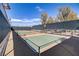 Outdoor pickle ball court ready for a game with net, benches, and fencing at 709 Corelli Cove St, Henderson, NV 89011