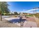 Landscaped outdoor area with bocce ball court, seating and manicured greenery at 709 Corelli Cove St, Henderson, NV 89011