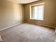 Cozy bedroom featuring neutral-toned walls, plush carpeting, and a sunlit window at 7300 Pirates Cove Rd # 2054, Las Vegas, NV 89145