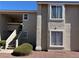 Neutral exterior showcasing the staircase of a well-maintained apartment building on a sunny day at 7300 Pirates Cove Rd # 2054, Las Vegas, NV 89145