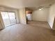 Spacious living area leading to a balcony with ample natural light and neutral carpeting at 7300 Pirates Cove Rd # 2054, Las Vegas, NV 89145