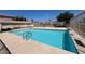 Community pool with clear water and poolside amenities under a bright blue sky at 7300 Pirates Cove Rd # 2054, Las Vegas, NV 89145