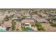 An aerial view of a home with a pool, covered patio, tile roof, and desert landscaping in a residential area at 7719 Villa Montara St, Las Vegas, NV 89123