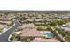 An aerial view of a home with a pool, covered patio, tile roof, and desert landscaping in a residential area at 7719 Villa Montara St, Las Vegas, NV 89123