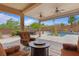 Inviting backyard featuring a sparkling pool, lush landscaping, and comfortable seating under a covered patio at 7719 Villa Montara St, Las Vegas, NV 89123