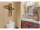 Charming powder room with decorative mirror, brown vanity, and elegant decor accents at 7719 Villa Montara St, Las Vegas, NV 89123