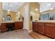 Elegant bathroom featuring dual vanities with rich wood cabinetry at 7719 Villa Montara St, Las Vegas, NV 89123
