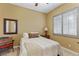 Bright bedroom with neutral paint, shuttered windows, comfortable bed, and cozy chair at 7719 Villa Montara St, Las Vegas, NV 89123