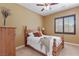 Cozy bedroom with a ceiling fan and window at 7719 Villa Montara St, Las Vegas, NV 89123