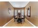 Intimate dining room featuring a round table, four chairs, and abundant natural light from the window at 7719 Villa Montara St, Las Vegas, NV 89123
