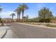 A grand entrance to the Finisterre neighborhood lined with tall palm trees on a beautiful, sunny day at 7719 Villa Montara St, Las Vegas, NV 89123