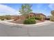 Single-story home with desert landscaping, including shrubs and succulents, with a three car garage at 7719 Villa Montara St, Las Vegas, NV 89123