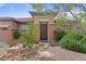 Charming front entrance featuring a decorative door, desert landscaping, and tasteful exterior color scheme at 7719 Villa Montara St, Las Vegas, NV 89123