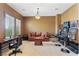 Entertaining game room with sofa, desk, slots, and bar stools, perfect for hosting guests at 7719 Villa Montara St, Las Vegas, NV 89123