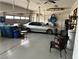 Spacious two car garage with a vehicle, garage doors, seating, and storage containers at 7719 Villa Montara St, Las Vegas, NV 89123