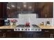 Gourmet kitchen features stainless steel JennAir appliances and dark wood cabinetry at 7719 Villa Montara St, Las Vegas, NV 89123