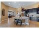 Bright and open kitchen with granite countertops, dark cabinetry, and seamless access to the dining area at 7719 Villa Montara St, Las Vegas, NV 89123
