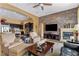 Open-concept living room with fireplace, backyard access and a glimpse of the kitchen at 7719 Villa Montara St, Las Vegas, NV 89123