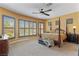Spacious main bedroom featuring a four-poster bed and large windows at 7719 Villa Montara St, Las Vegas, NV 89123
