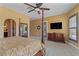 Main bedroom with four-poster bed, backyard access, and ensuite bath at 7719 Villa Montara St, Las Vegas, NV 89123