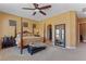 Comfortable main bedroom with four-poster bed, ceiling fan, and ample natural light at 7719 Villa Montara St, Las Vegas, NV 89123
