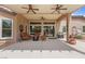 Spacious covered patio with ceiling fans, outdoor seating, and a built-in grill, perfect for entertaining at 7719 Villa Montara St, Las Vegas, NV 89123