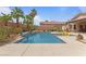 Backyard featuring a swimming pool, desert landscaping, and comfortable seating areas for outdoor enjoyment at 7719 Villa Montara St, Las Vegas, NV 89123