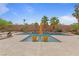 Tranquil backyard showcasing a sparkling pool, patio area, desert landscaping, and comfortable lounge chairs at 7719 Villa Montara St, Las Vegas, NV 89123