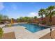 Backyard oasis with a sparkling pool, well-manicured desert landscape, and inviting patio area with lounge chairs at 7719 Villa Montara St, Las Vegas, NV 89123