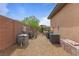 A practical side yard with gravel, brick perimeter, and equipment that may support a swimming pool at 7719 Villa Montara St, Las Vegas, NV 89123