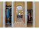 Open walk-in closet featuring built in shelving and access to the main bath at 7719 Villa Montara St, Las Vegas, NV 89123