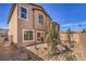 Exterior view of a two-story home featuring a xeriscaped backyard and patio at 794 Calm Crystal Ct # Lot 139, North Las Vegas, NV 89081