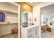 Stylish bathroom featuring a walk-in closet, vanity, mirror, and neutral decor at 794 Calm Crystal Ct # Lot 139, North Las Vegas, NV 89081